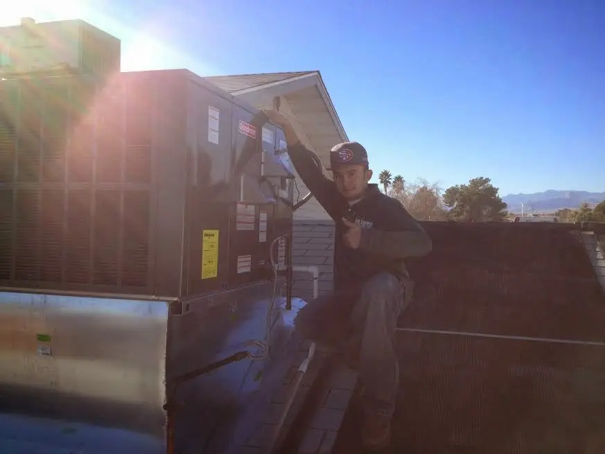 HVAC technician performing AC Tune-Up on a rooftop unit in Lower Makefield